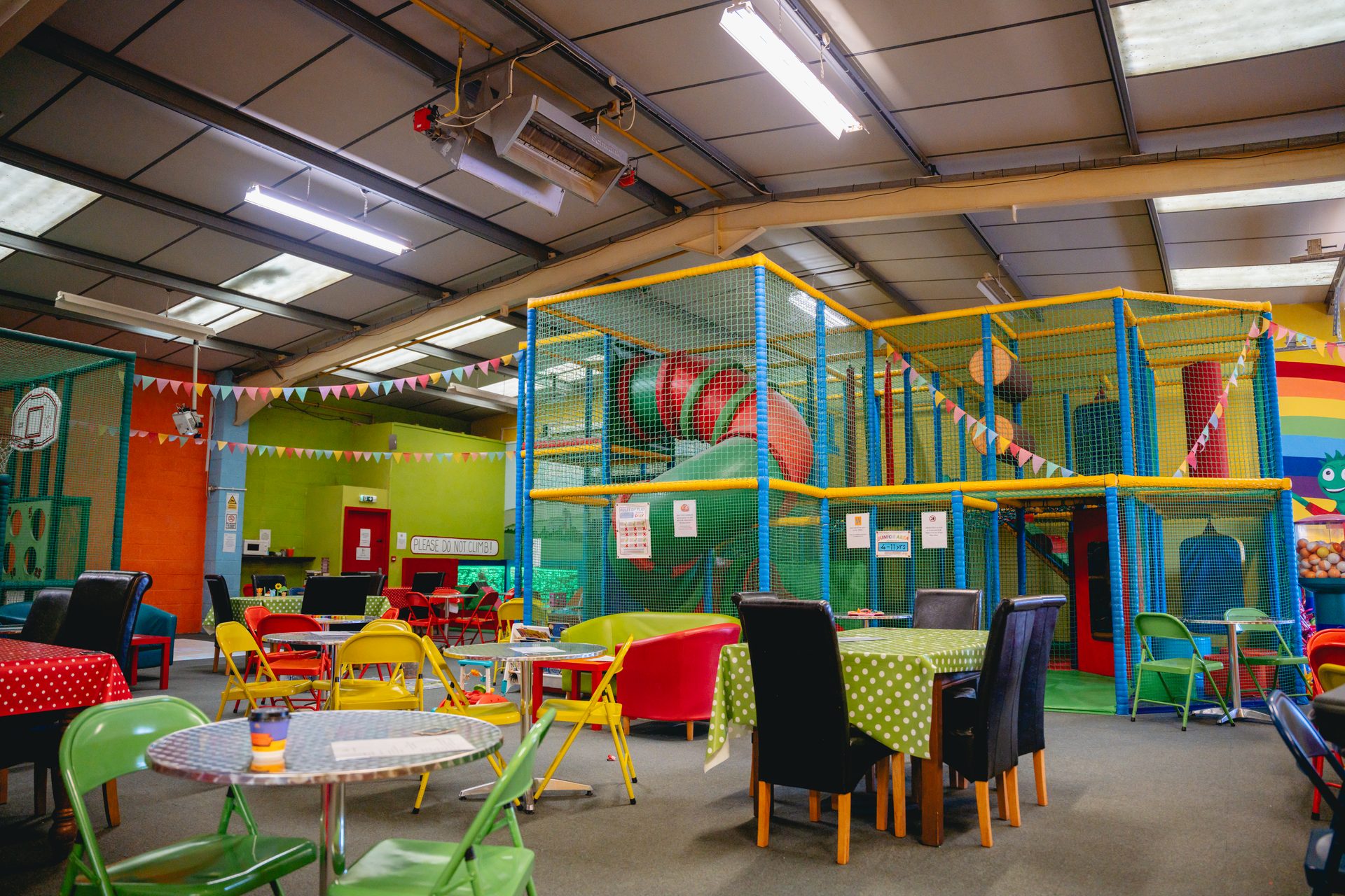 Inside Leaping Lizards Play Centre — play frame and café tables